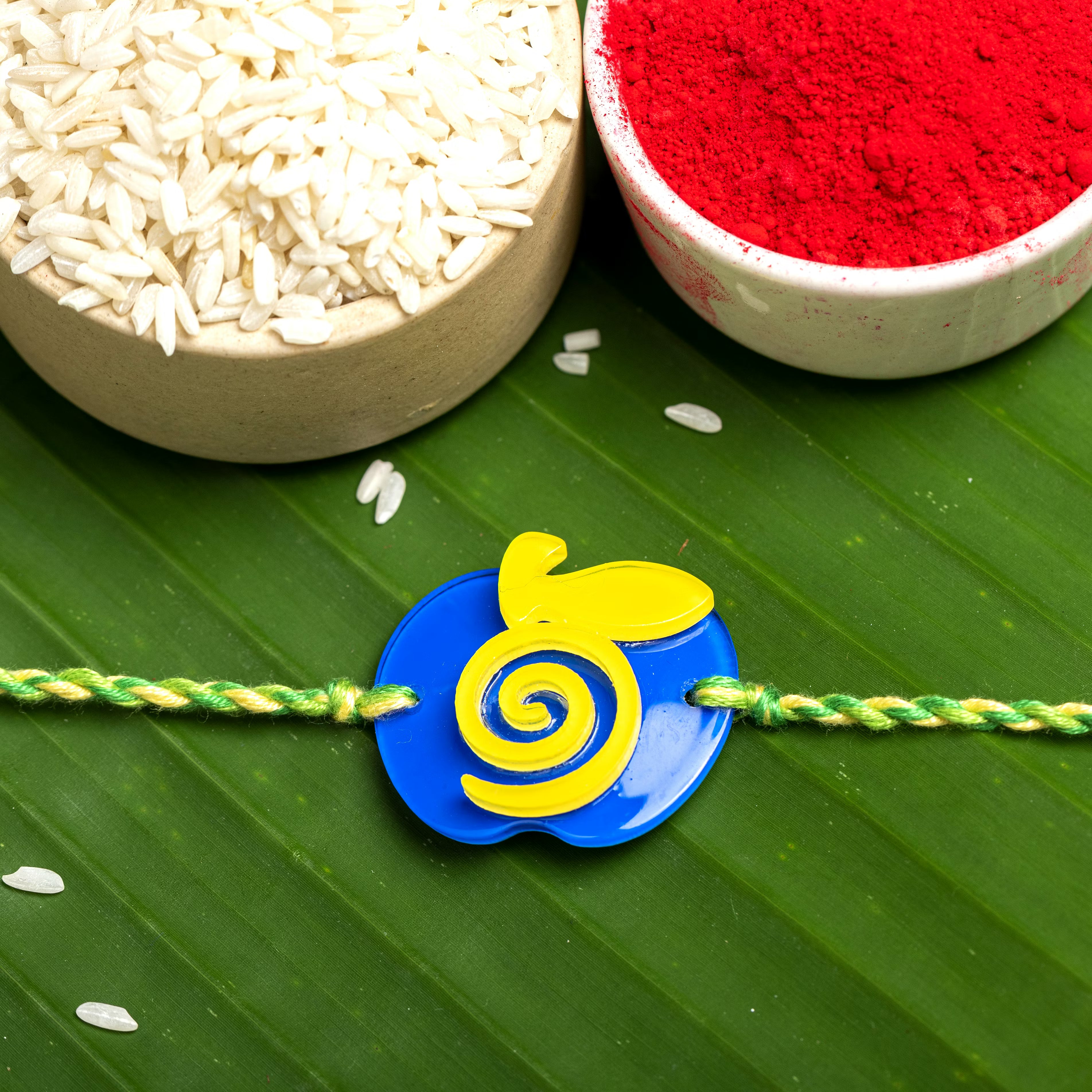 Acrylic Blue Yellow Apple Rakhi with Green Yellow Dori Roli Chawal for Boys and Kids - Lookandadorn.com