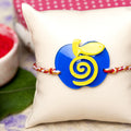 Acrylic Blue Yellow Apple Rakhi with White Red Golden Dori Roli Chawal for Boys and Kids - Lookandadorn.com