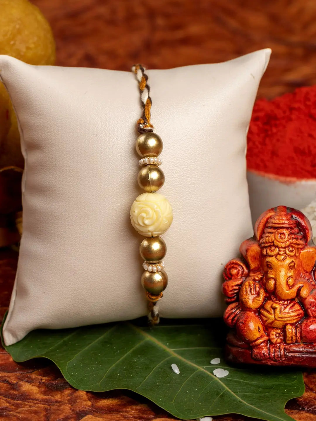 Handmade Beige Carved Bead Focal Golden Rakhi for Men and Boys with Roli Chawal - Lookandadorn.com