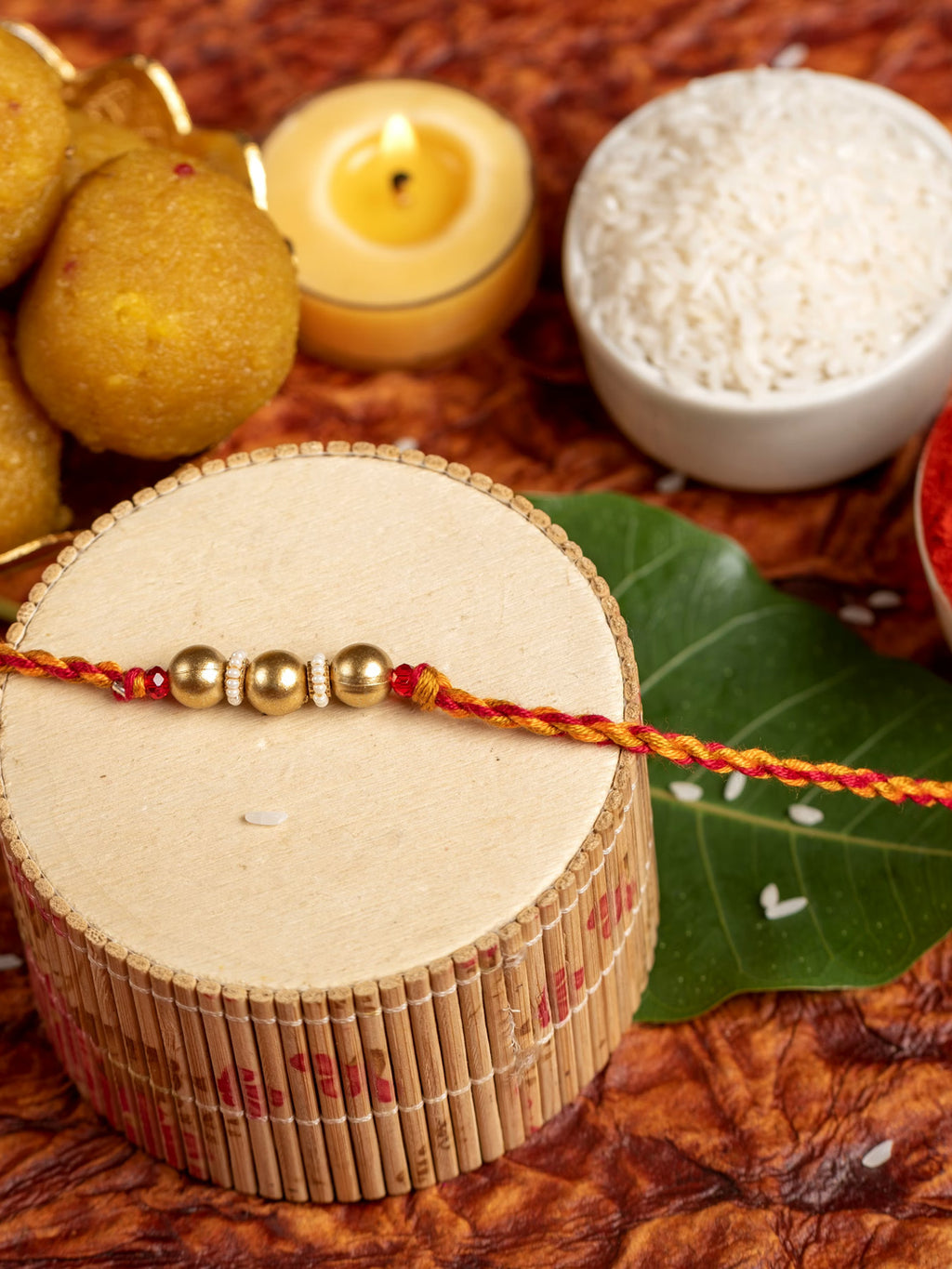 Designer Triplet Golden Bead Rakhi for Men and Boys with Roli Chawal - Lookandadorn.com
