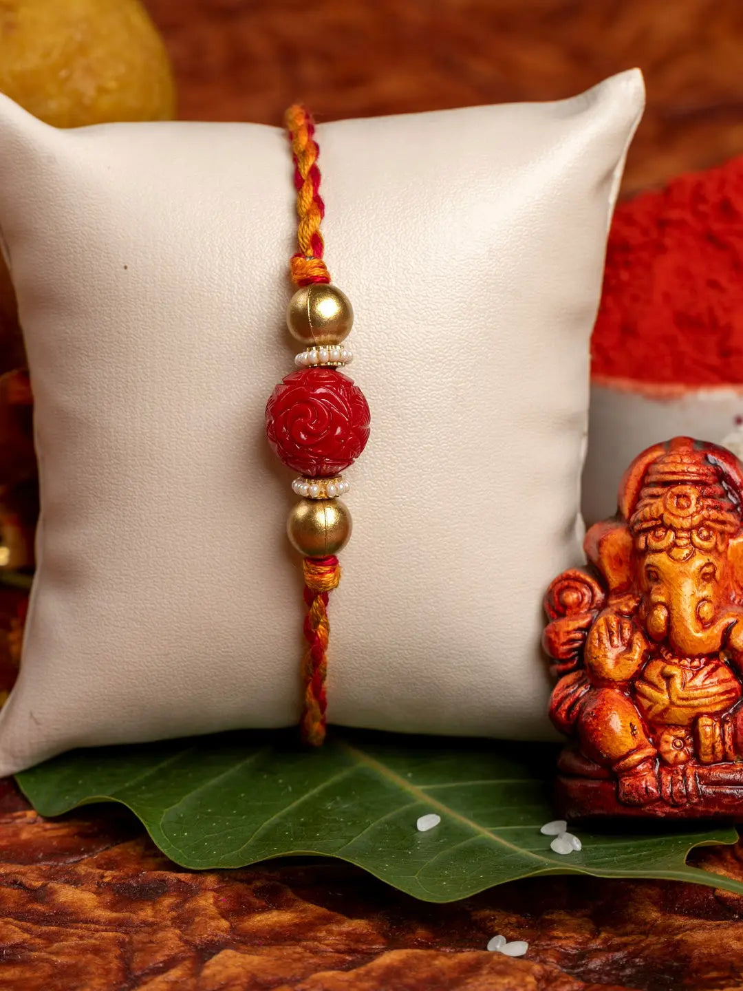 Handmade Red Carved Bead Focal Golden Rakhi for Men and Boys with Roli Chawal - Lookandadorn.com