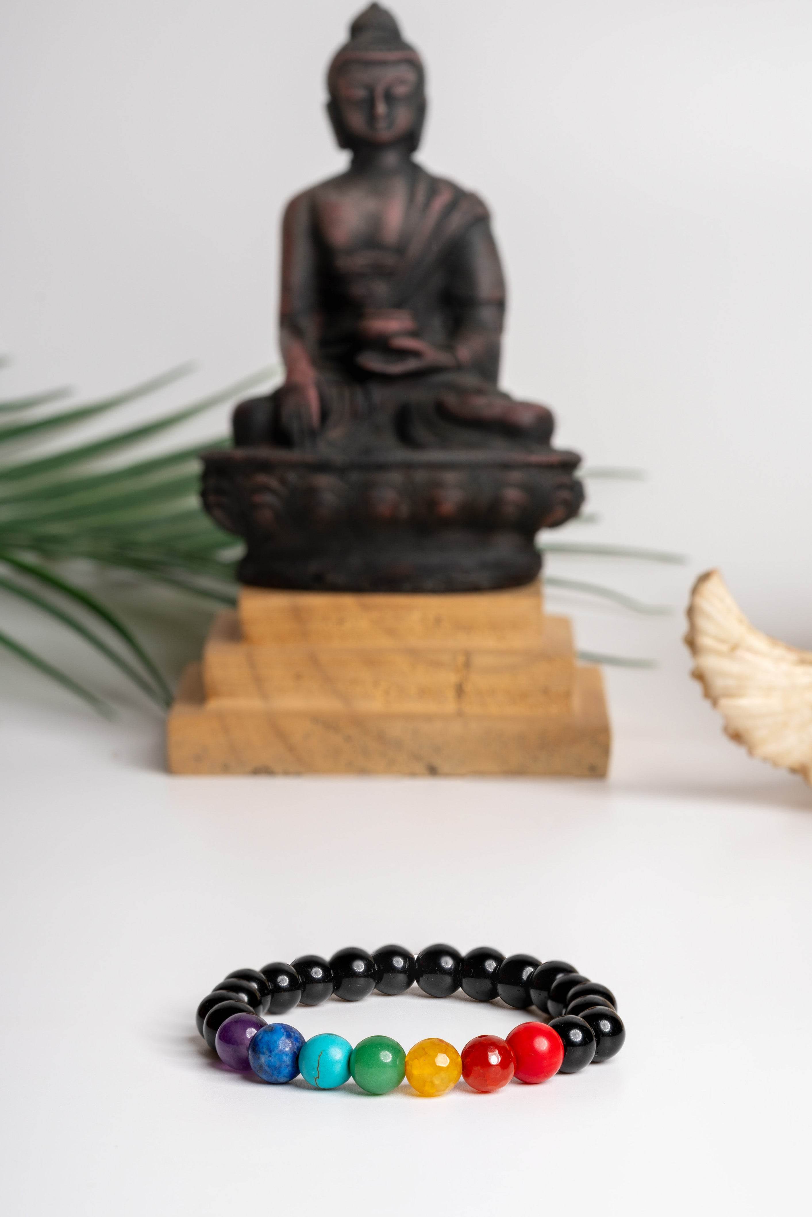 7 chakra bracelet featuring colorful gemstones on a black bead band for spiritual healing