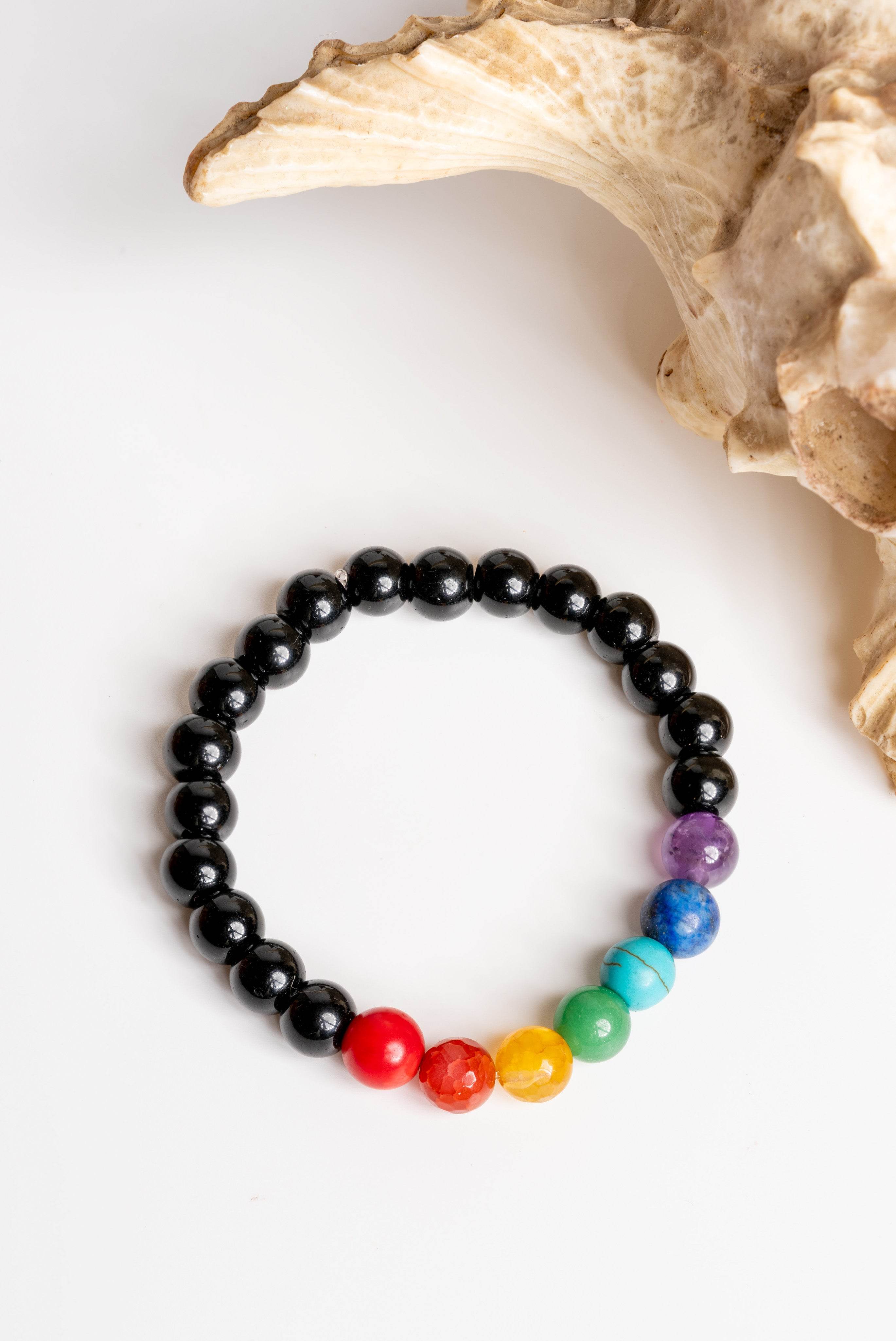 7 chakra bracelet made with colorful gemstones and black beads for balance and healing