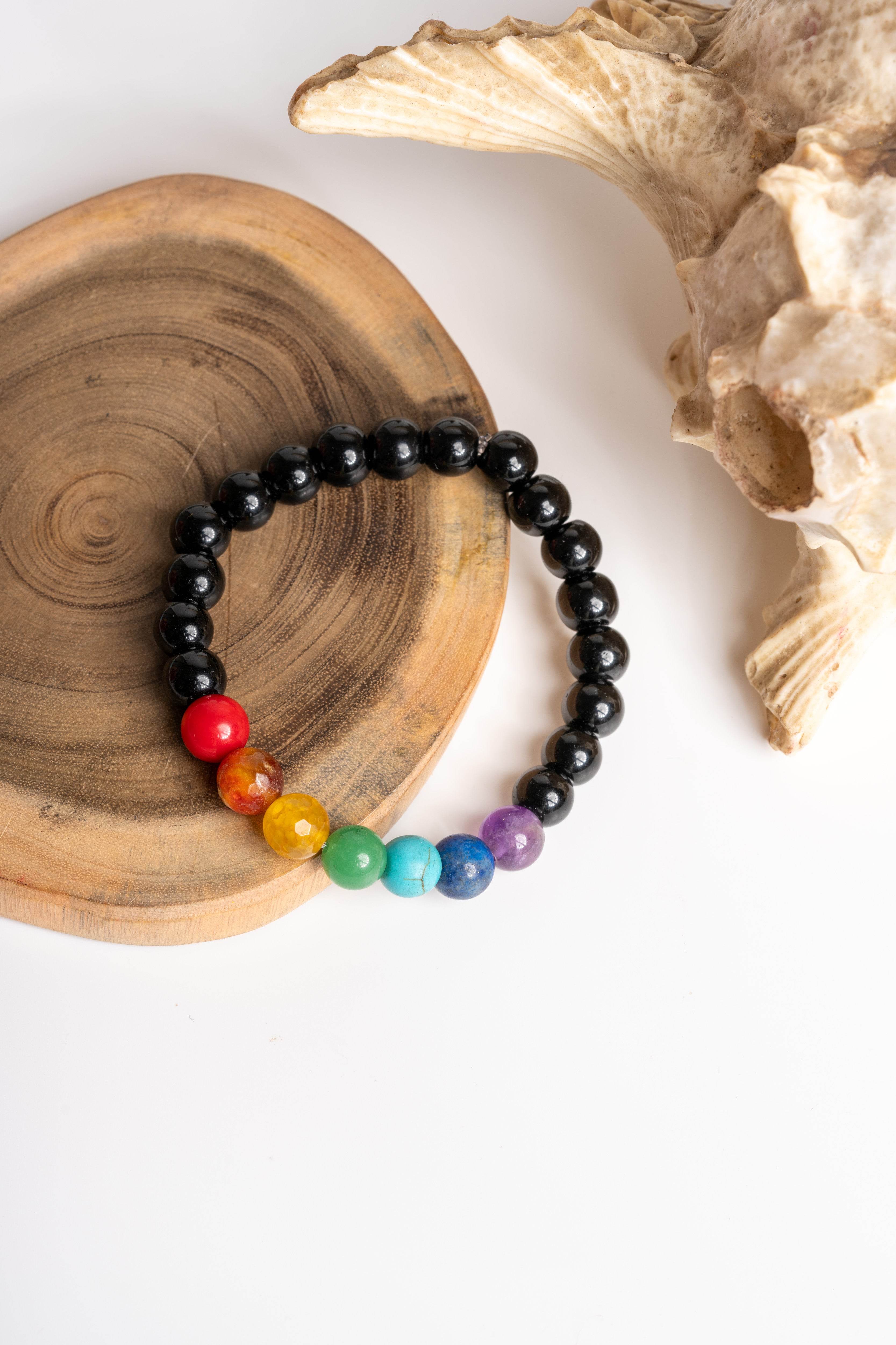 LOOK AND ADORN 7 chakra bracelet featuring vibrant beads on a black stretchy band for balance and healing