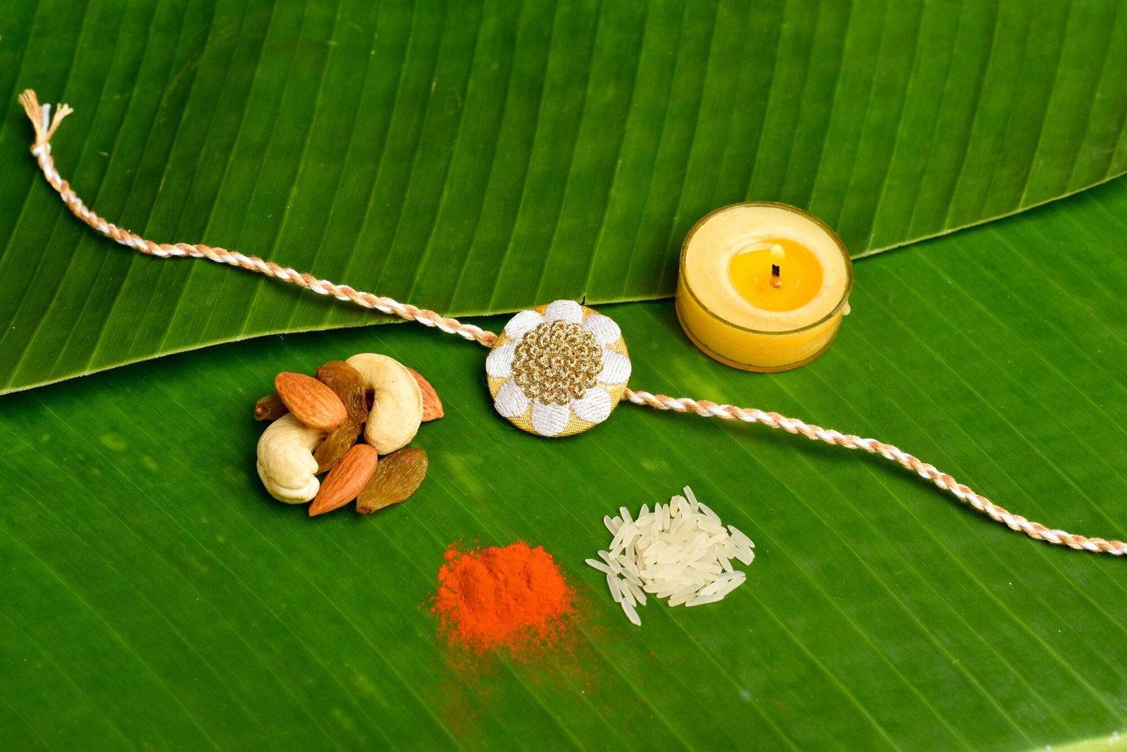 Elegant White Golden Floral Embroidery Rakhi Set with Roli and Chawal for Celebrating Raksha Bandhan - Lookandadorn.com