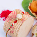 Handmade Designer Pearl Focal Rakhi with Red Crystal, Roli & Chawal for Brother - Traditional & Stylish - Lookandadorn.com
