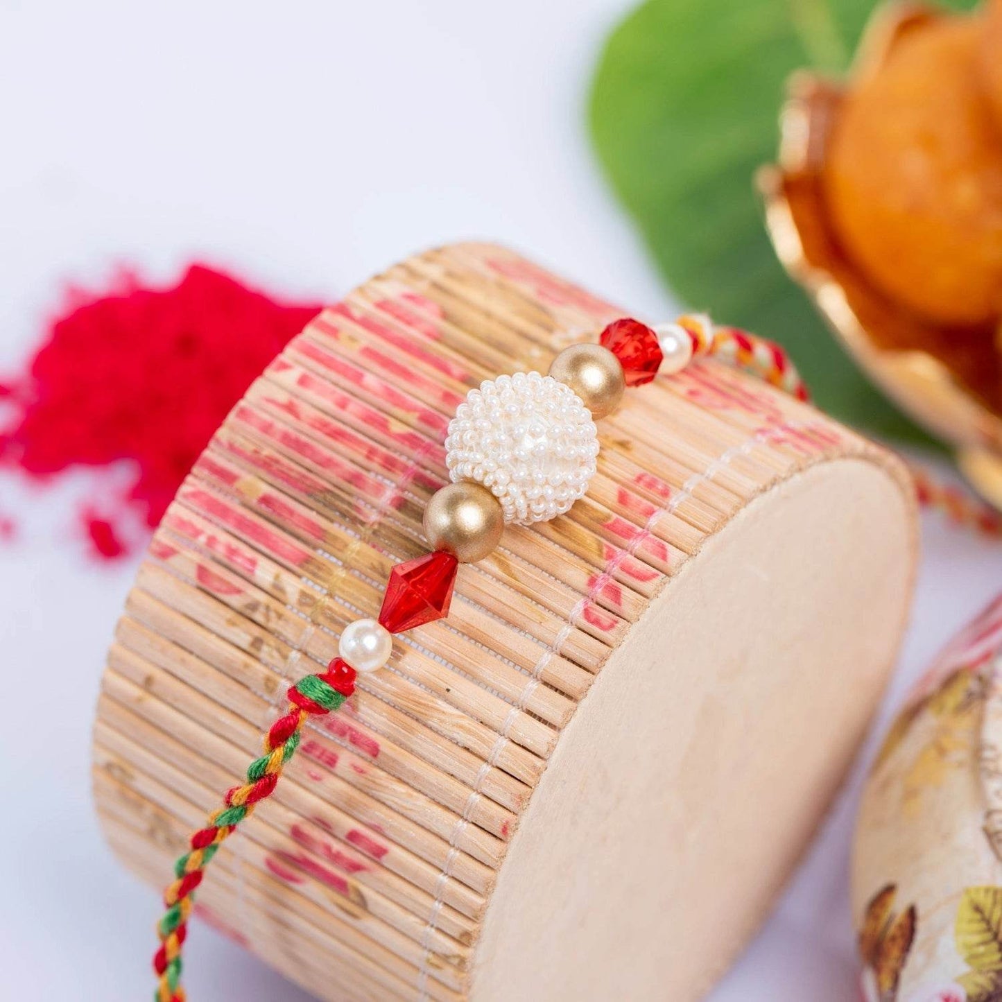 Handmade Designer Pearl Focal Rakhi with Red Crystal, Roli & Chawal for Brother - Traditional & Stylish - Lookandadorn.com