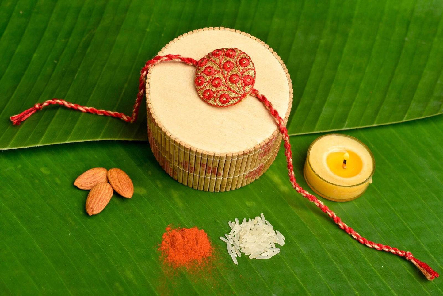 Handmade Red Golden Embroidery Set with Roli and Chawal for Brothers - Designer Rakhi Online - Lookandadorn.com