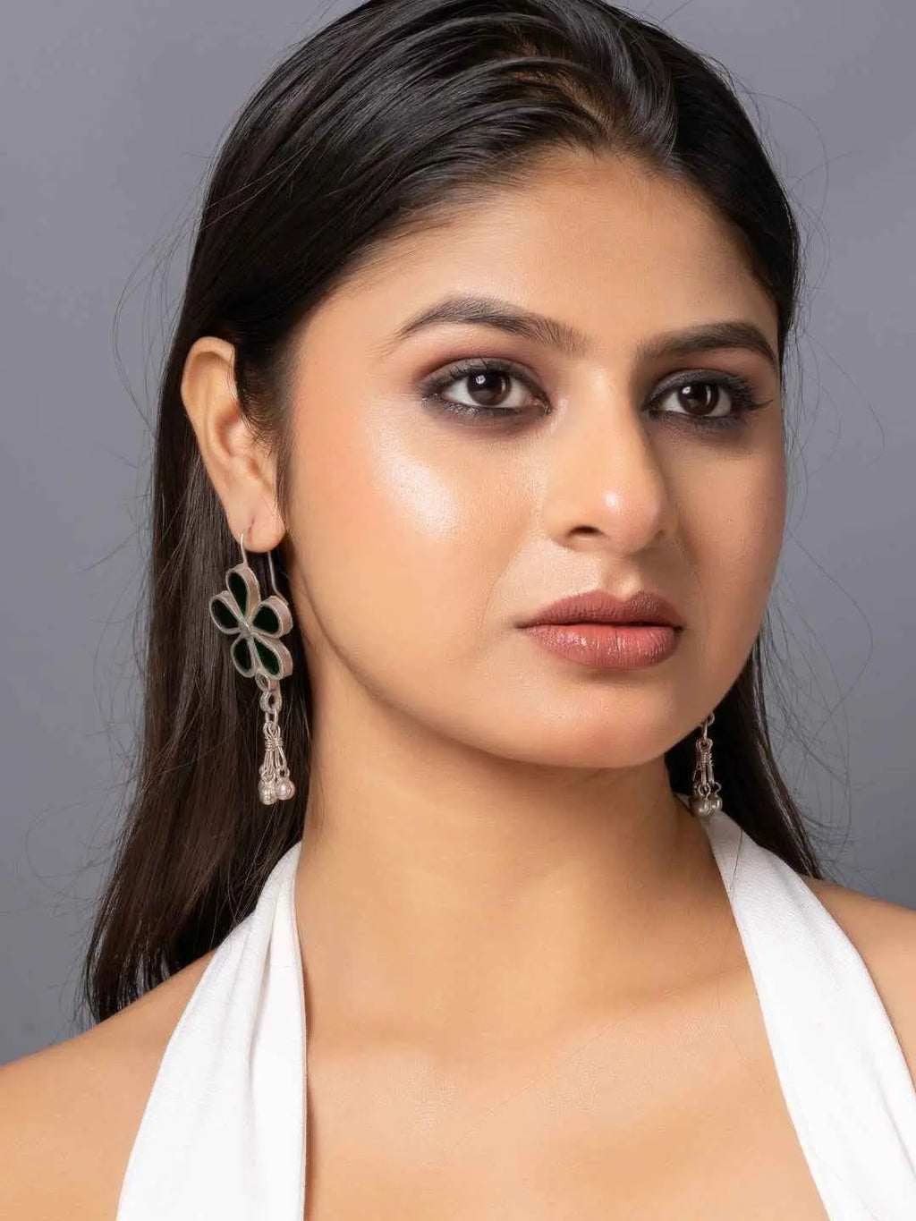 Oxidized silver Afghani earrings featuring green floral design with hanging charms