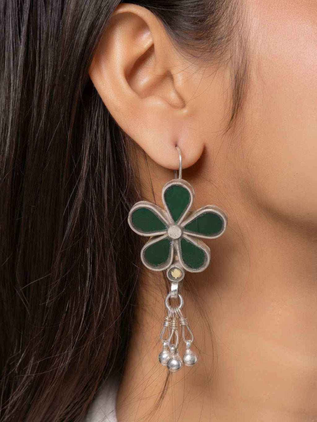 Oxidized silver Afghani earrings featuring a green flower design with dangling beads