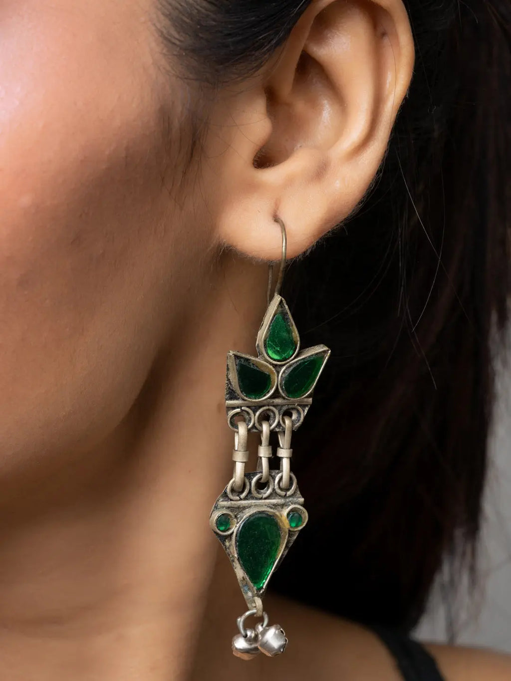 LOOK AND ADORN Afghani earrings with green stones and intricate silver design worn on ear