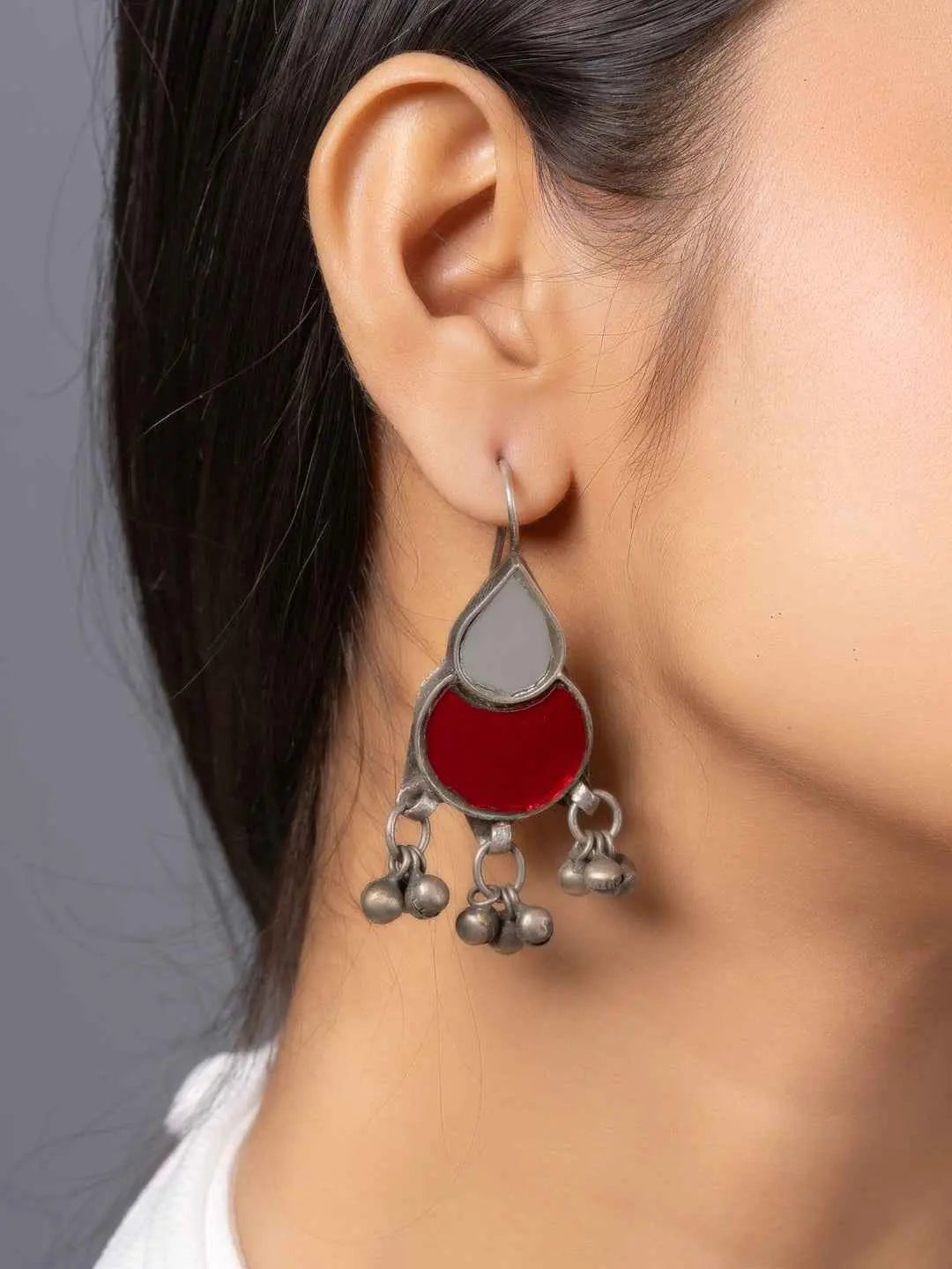 Oxidized silver afghani earrings featuring red and gray stones with decorative bells
