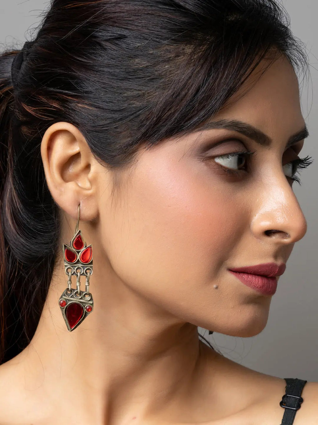 Woman wearing red and silver afghani earrings with intricate traditional design by LOOK AND ADORN