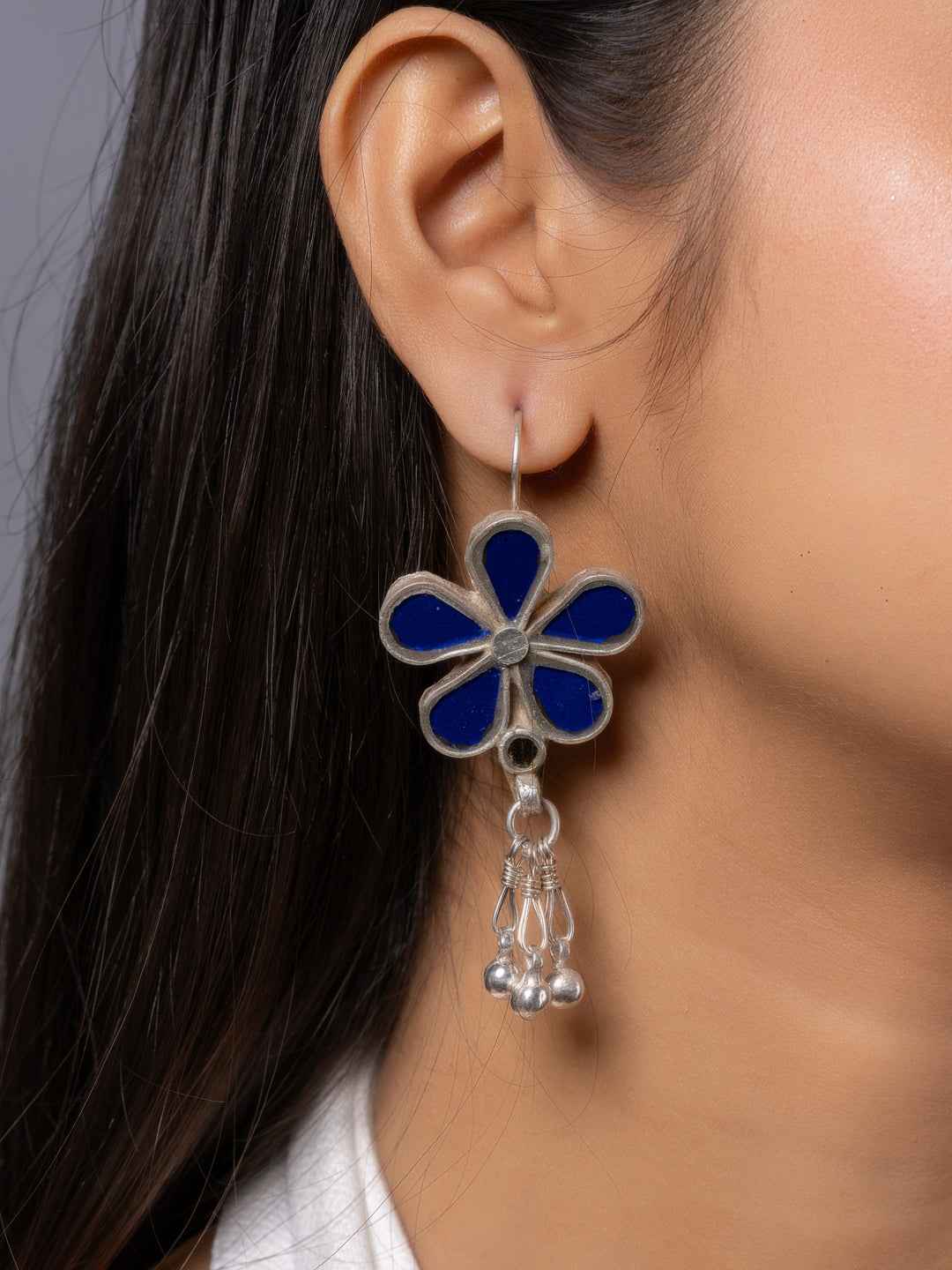 Blue and silver Afghani earrings with floral design and dangling beads for a chic look