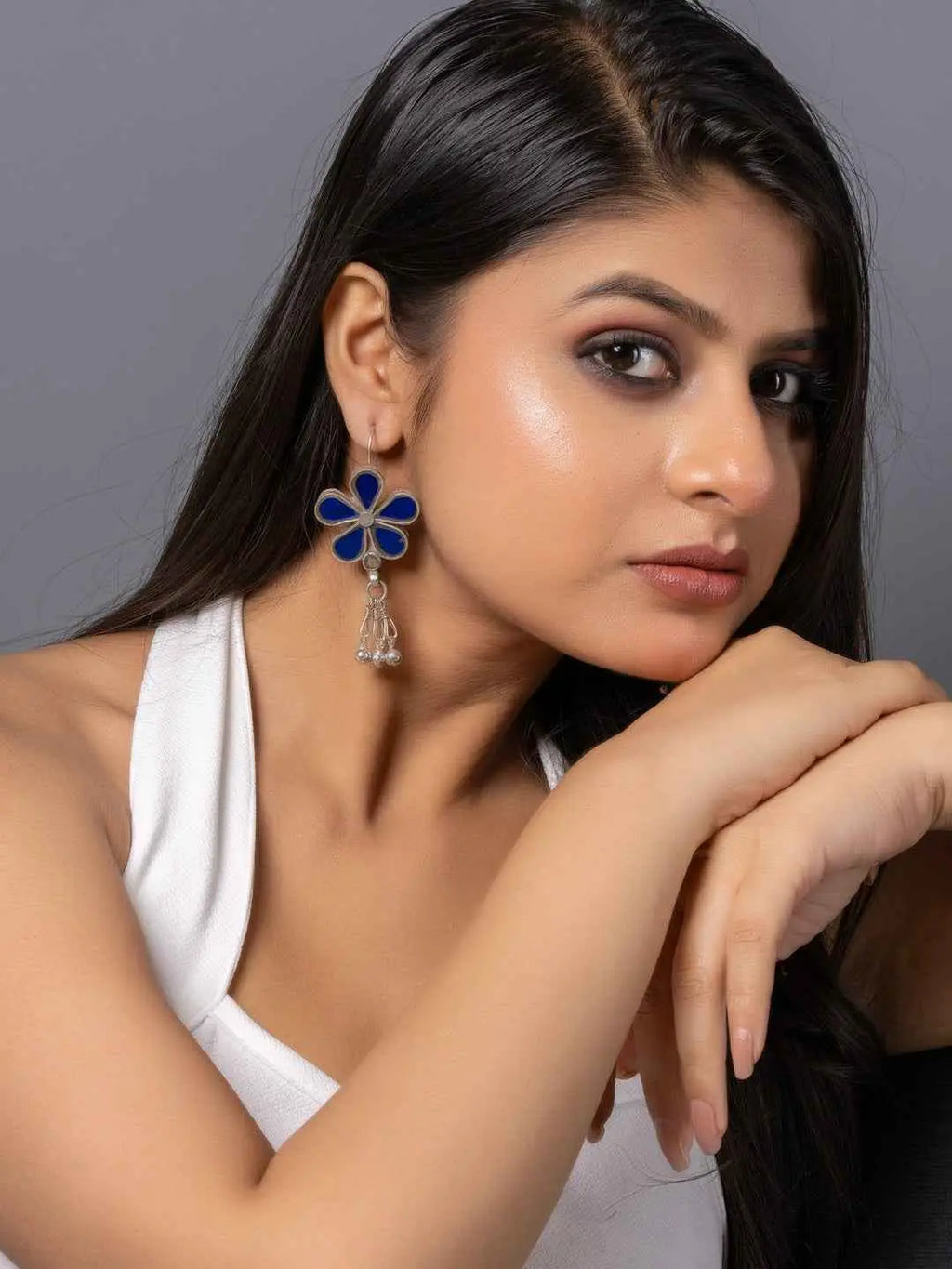 Blue enamel Afghani earrings with a floral design and dangling accents for a stylish look
