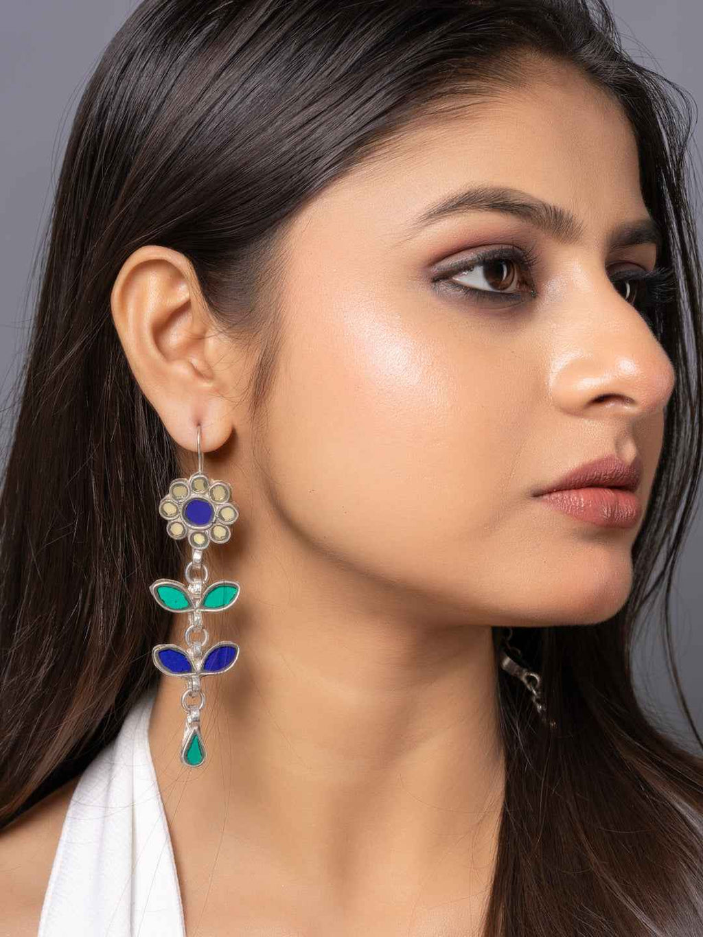 Colorful afghani earrings with floral design, featuring blue and green stones and a silver finish