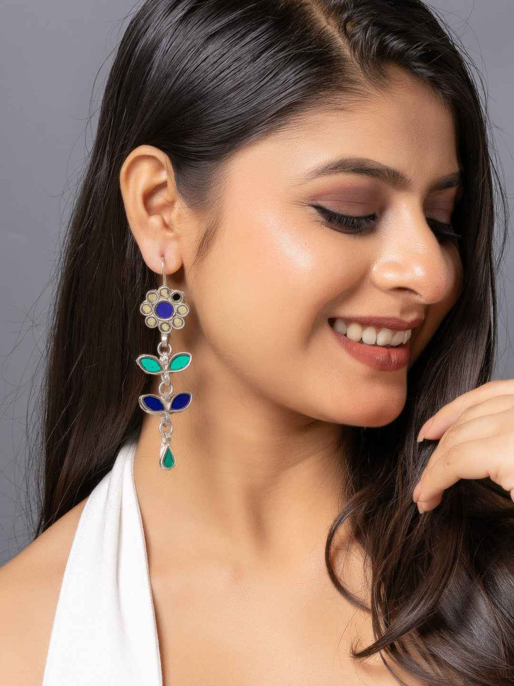 Colorful afghani earrings featuring blue stones and intricate floral design in gold tone