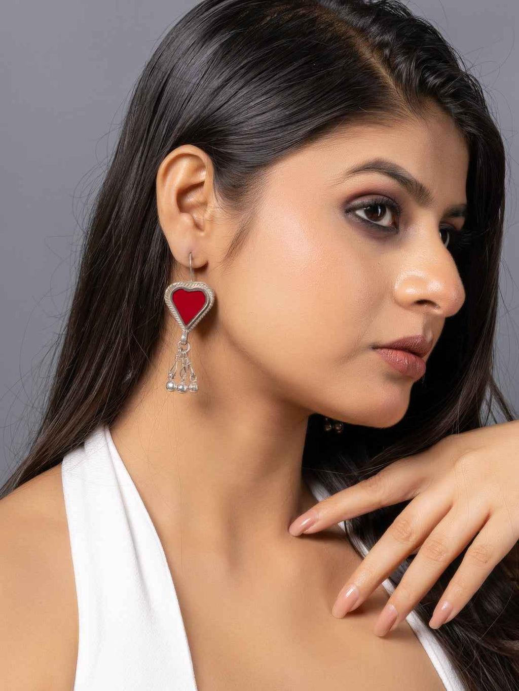 Oxidized silver Afghani earrings featuring a red heart design with dangling embellishments