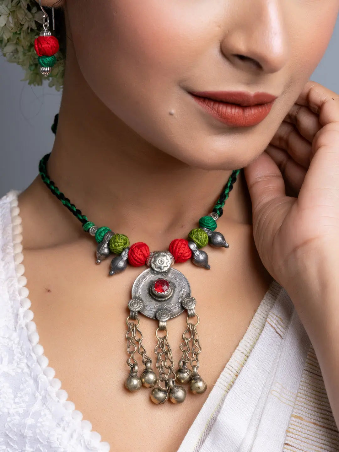 Afghani necklace set with silver pendant and red green beads worn by a woman from LOOK AND ADORN