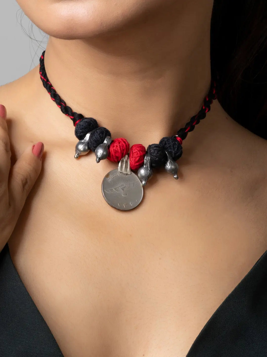 LOOK AND ADORN afghani pendant necklace with black and red beads and silver accents on braided cord