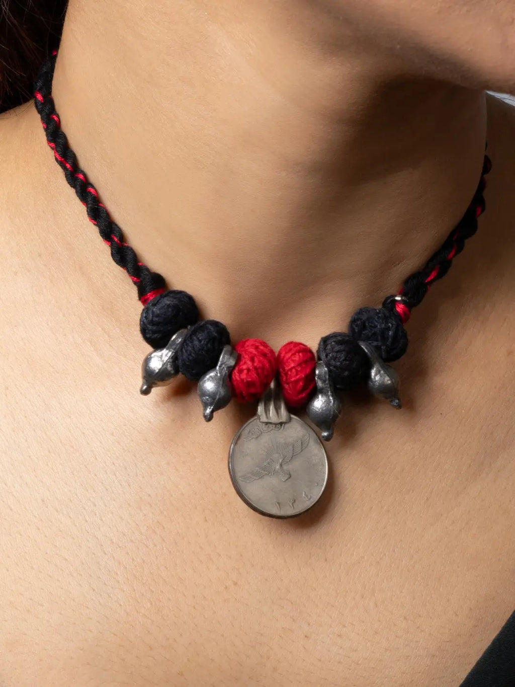 Afghani pendant necklace with black and red braided thread and silver decorative elements