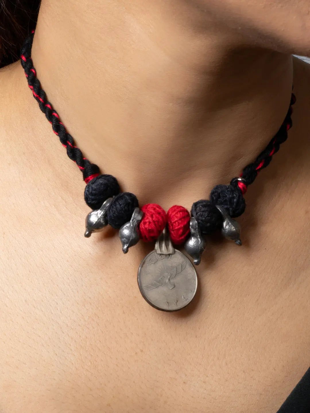 Afghani pendant necklace with black and red braided thread and silver decorative elements