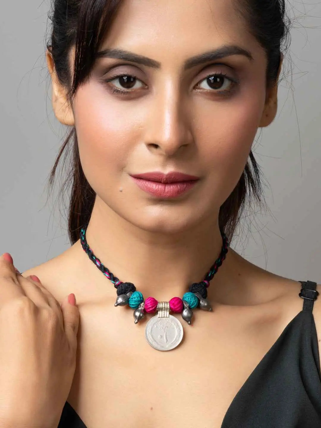 Woman wearing colorful Afghani pendant necklace with beads and braided cord from LOOK AND ADORN