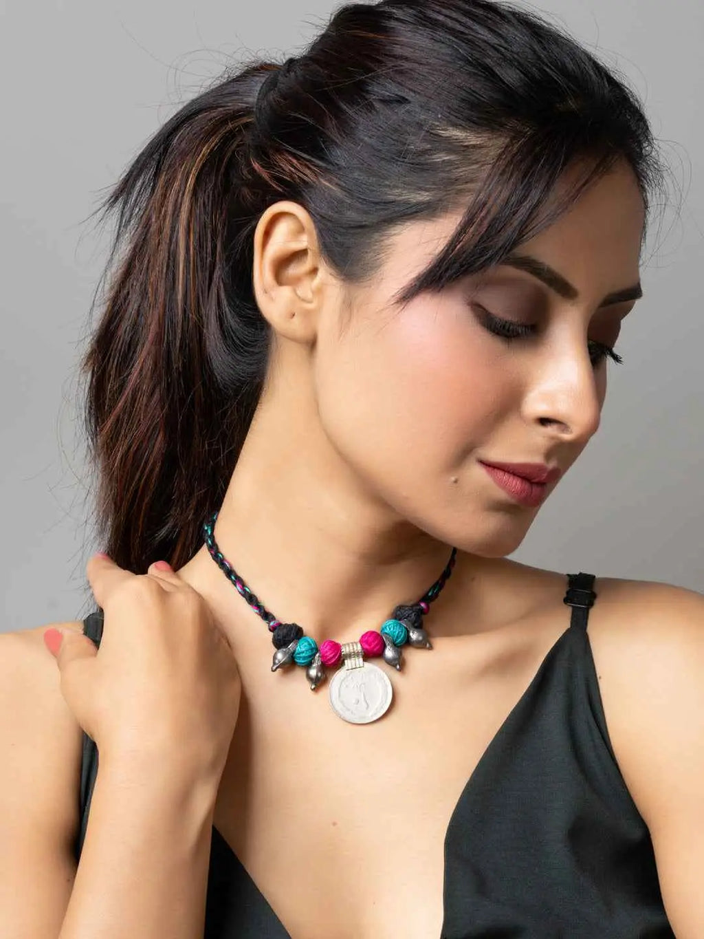 Woman wearing colorful Afghani pendant necklace with turquoise and pink beads by LOOK AND ADORN
