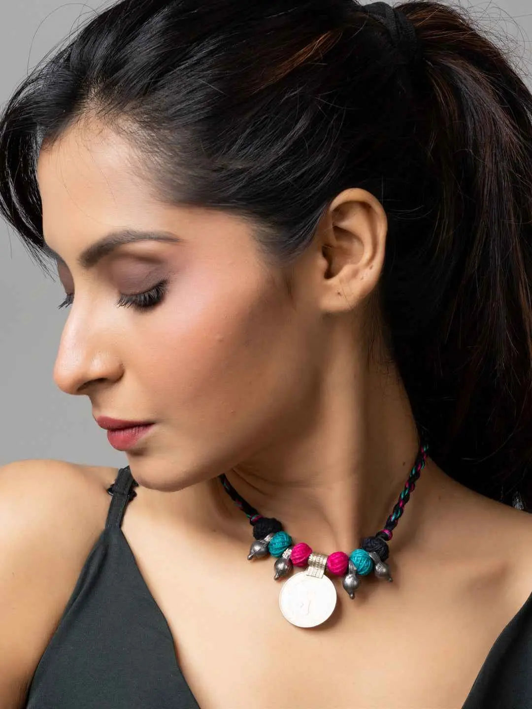 Close-up of woman wearing colorful Afghani pendant necklace from LOOK AND ADORN Afghani Jewellery collection