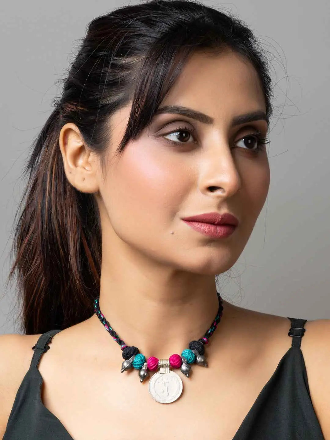 Woman wearing a colorful Afghani pendant necklace with beads from LOOK AND ADORN jewelry collection
