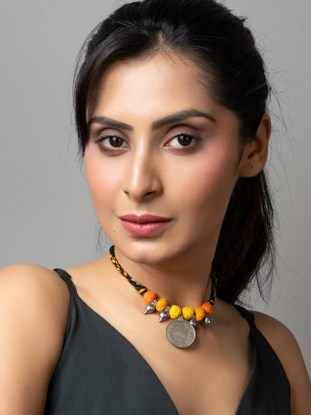 Woman wearing colorful Afghani pendant necklace with yellow and orange beads by LOOK AND ADORN