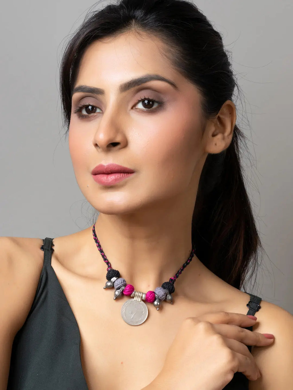 Woman wearing a colorful beaded Afghani pendant necklace with intricate traditional design