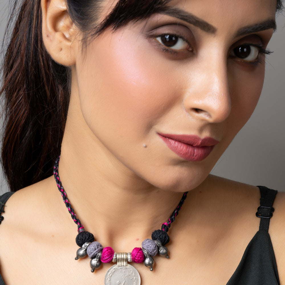 Close-up of woman wearing LOOK AND ADORN Afghani pendant necklace with colorful beads and coin charm