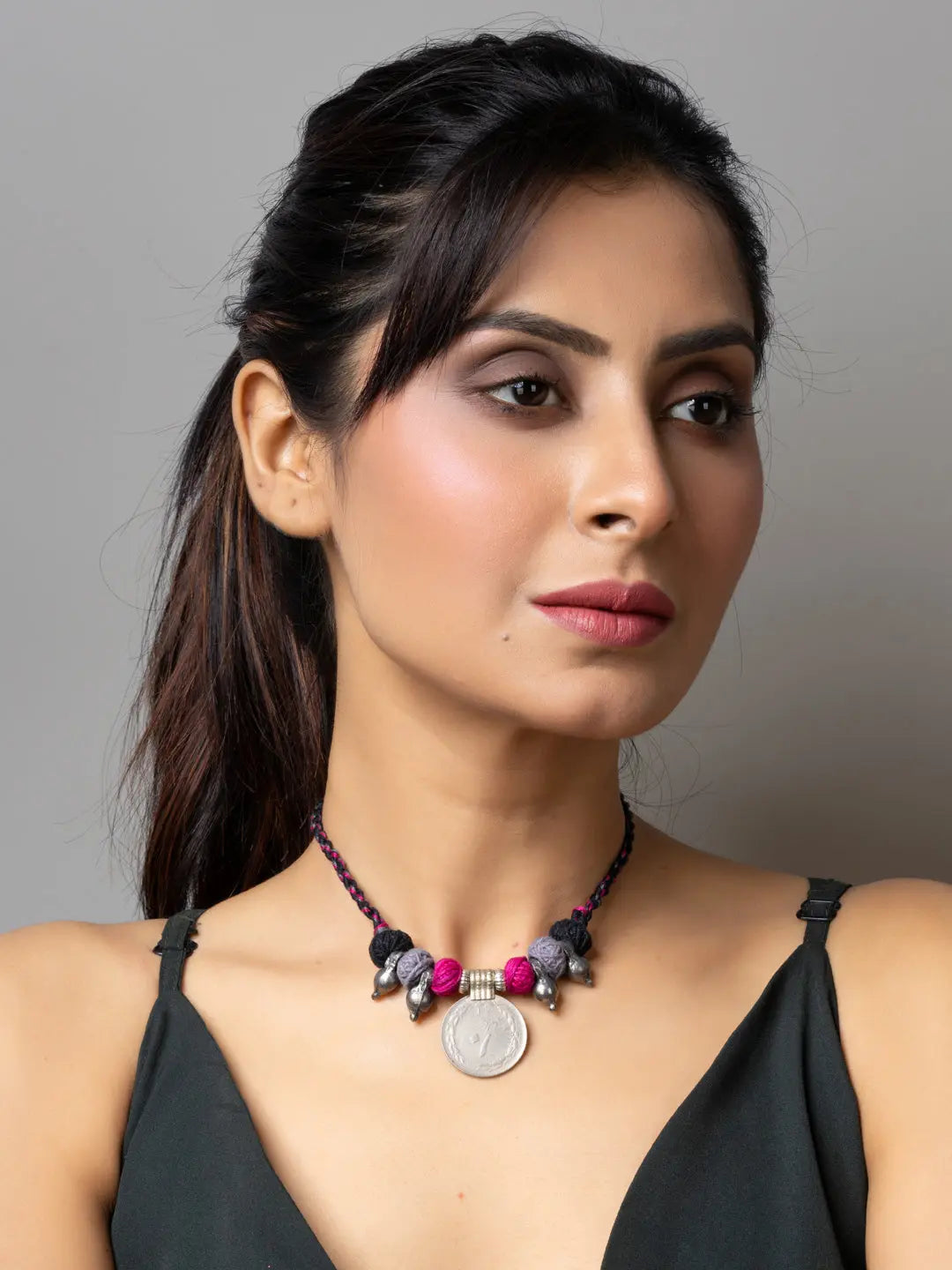 LOOK AND ADORN Afghani pendant necklace with beads and coin charm worn by woman