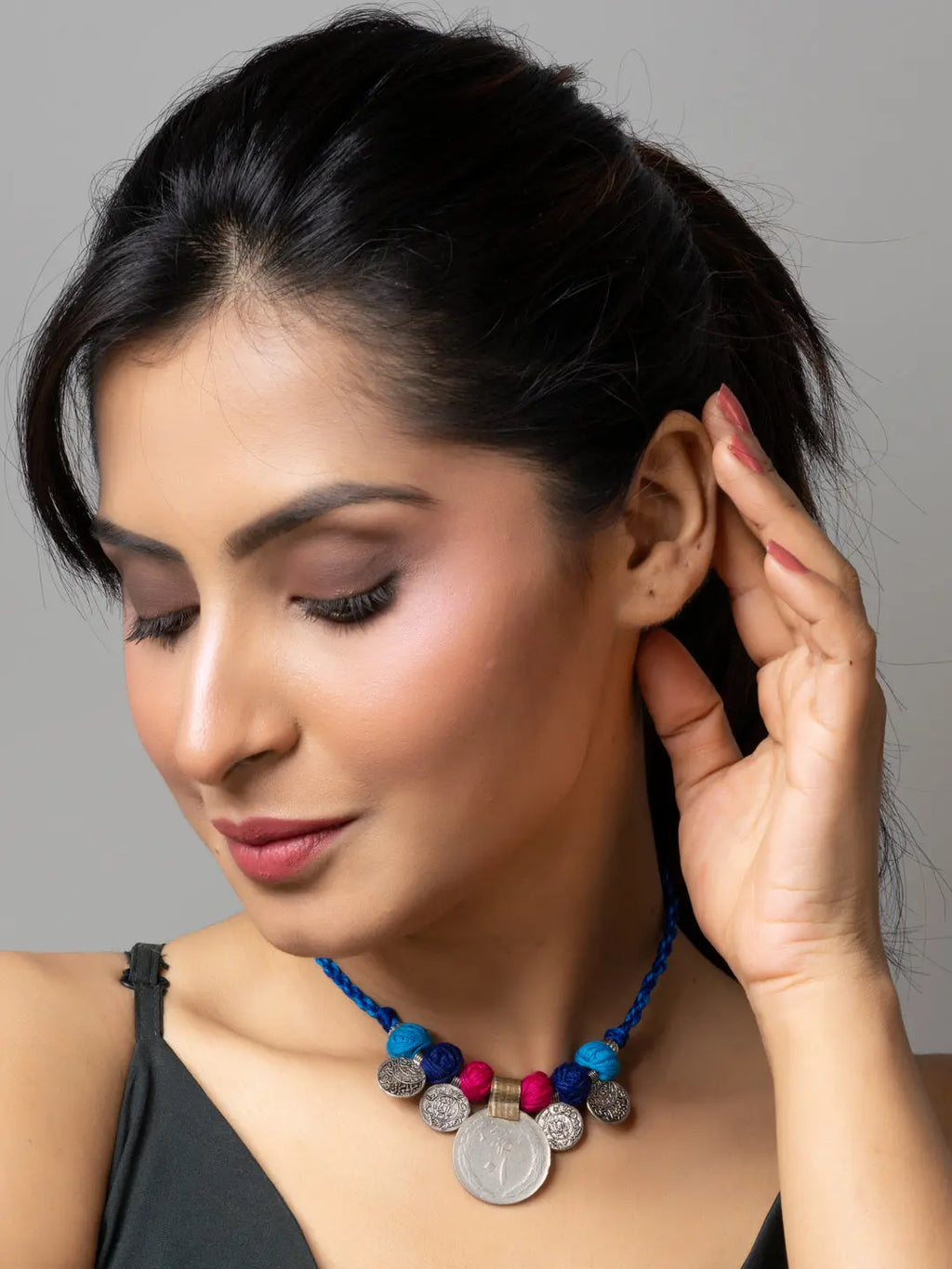 Woman wearing a colorful afghani pendant necklace with blue and pink beads by LOOK AND ADORN