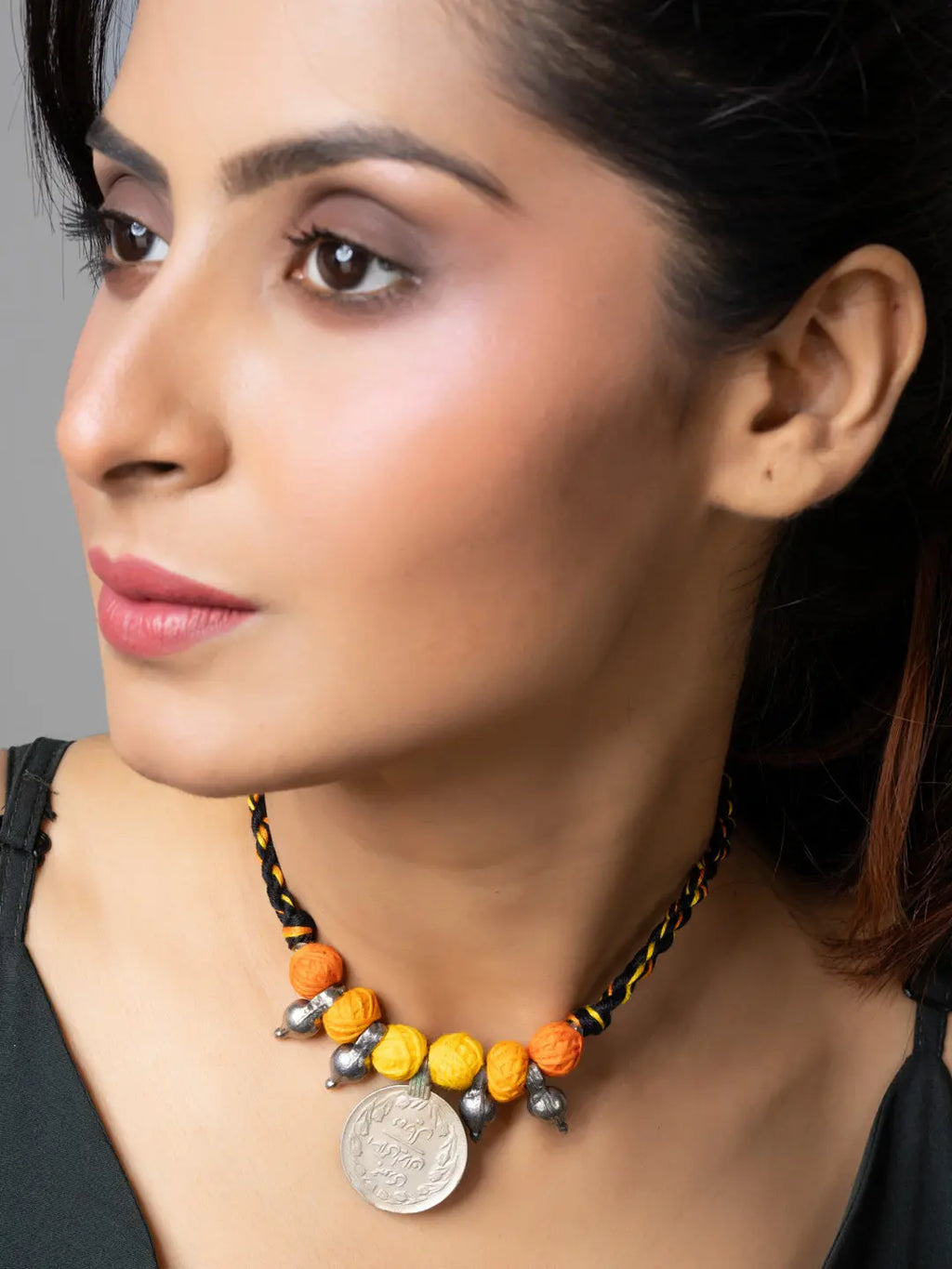 Afghani pendant necklace with colorful beads and silver coin worn by woman from LOOK AND ADORN