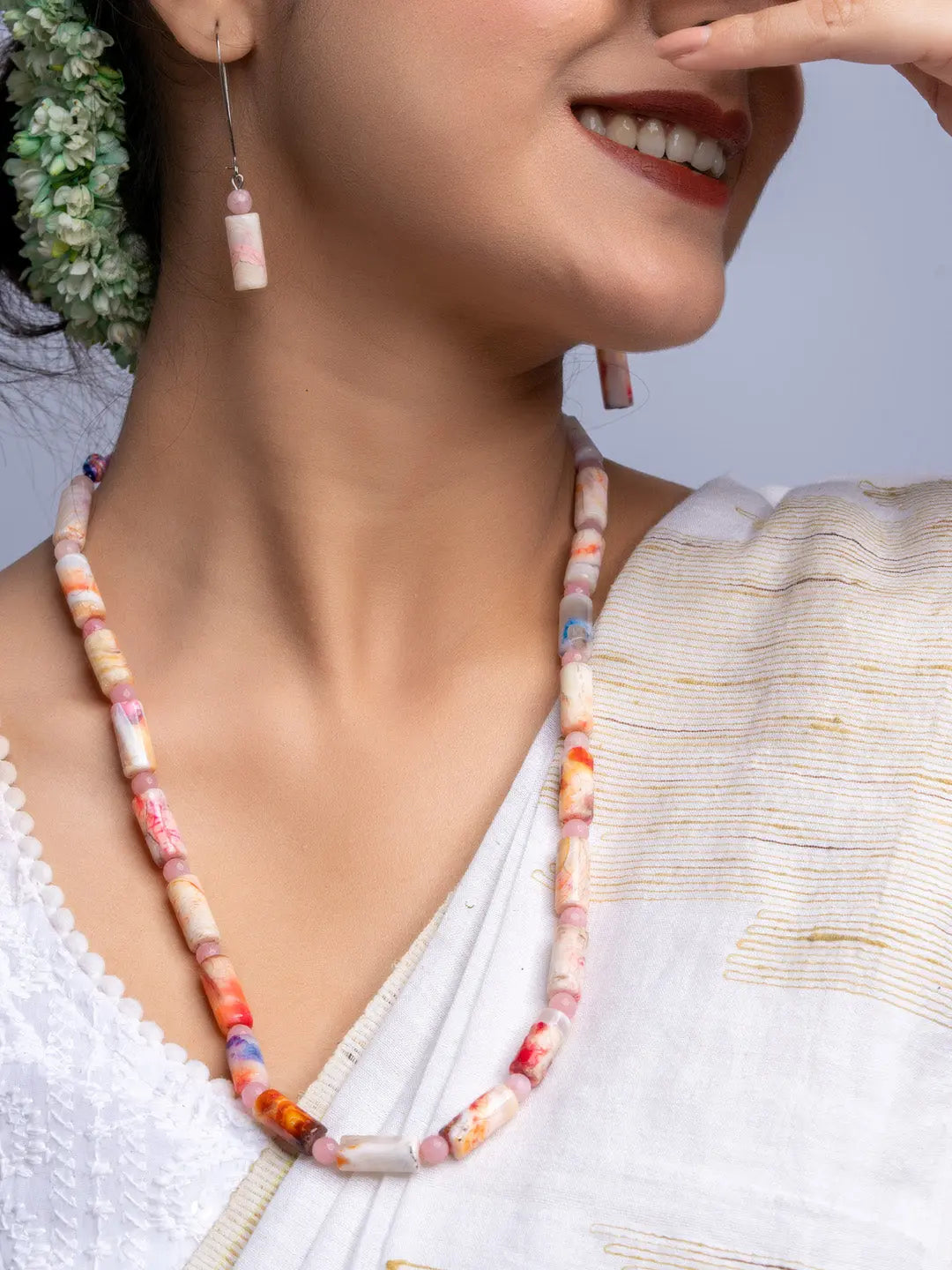 Handmade colorful agate necklace and matching earrings worn with traditional white attire