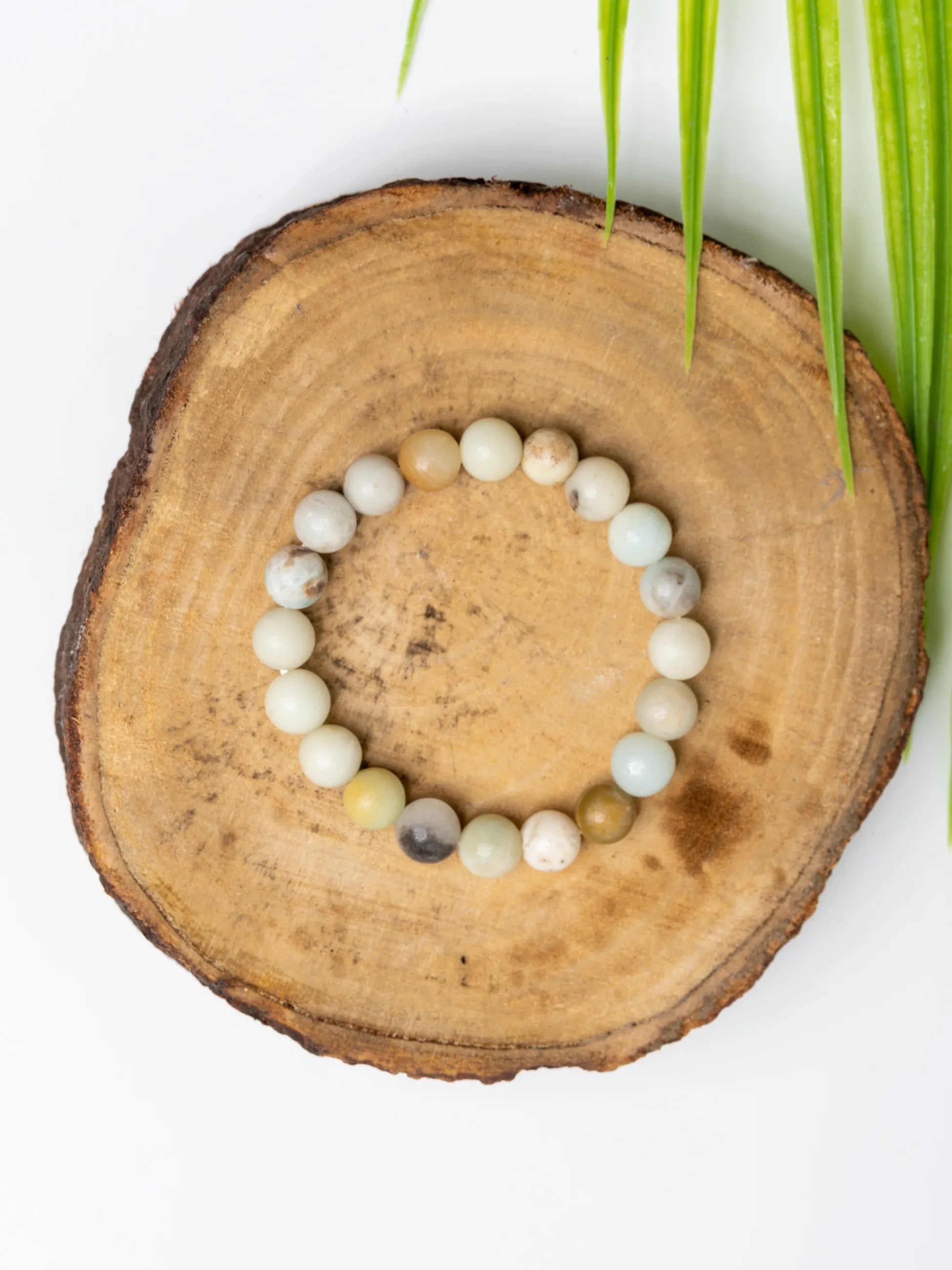 Beautiful amazonite bracelet made of natural gemstones on a wooden display for a stylish look