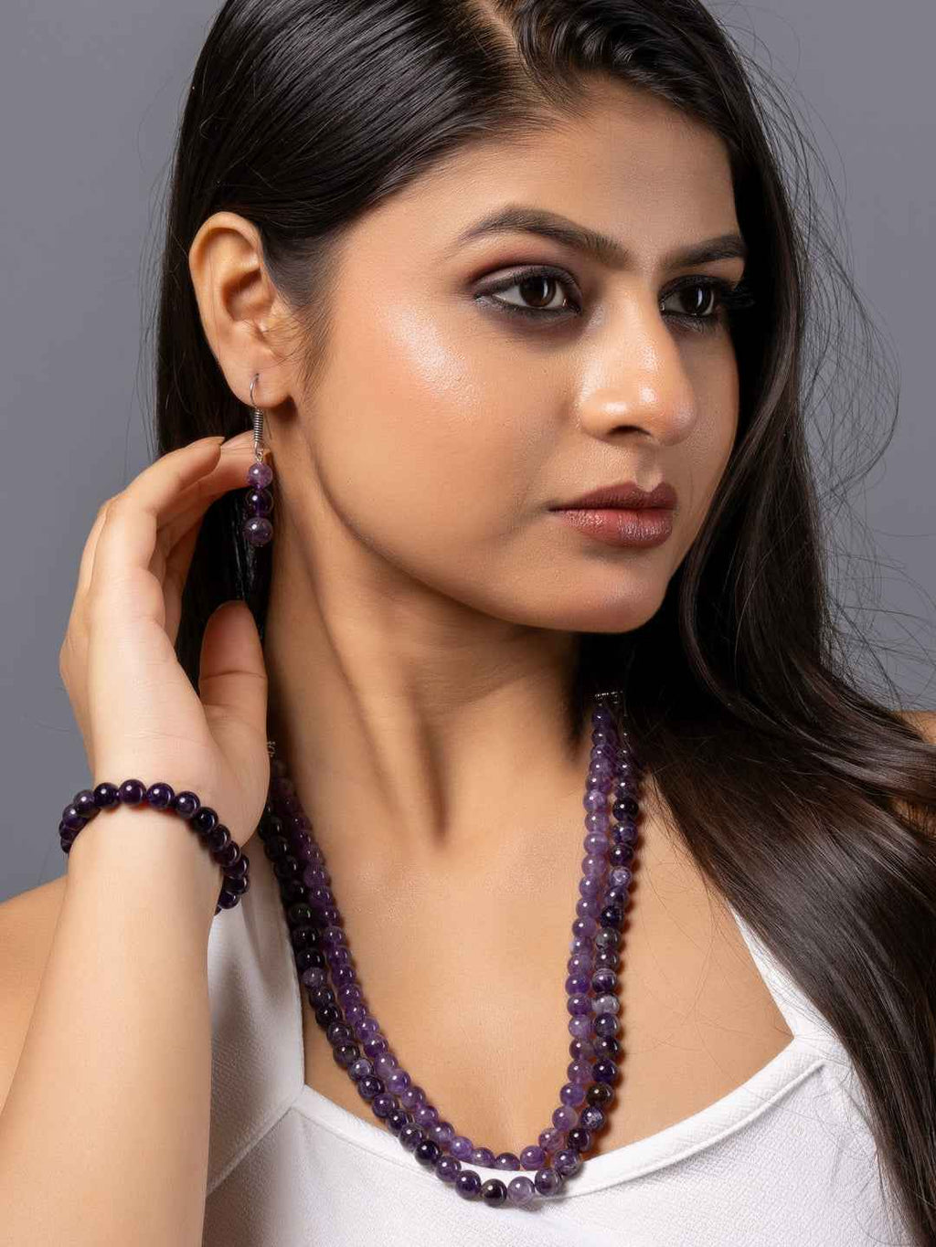 Elegant amethyst necklace set featuring deep purple beads with matching earrings and bracelet.