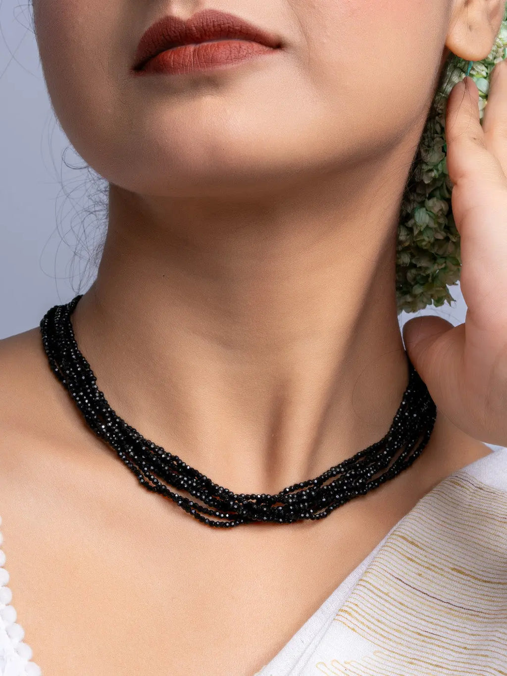 Handmade black crystal necklace with multiple strands worn by woman showcasing elegant jewelry