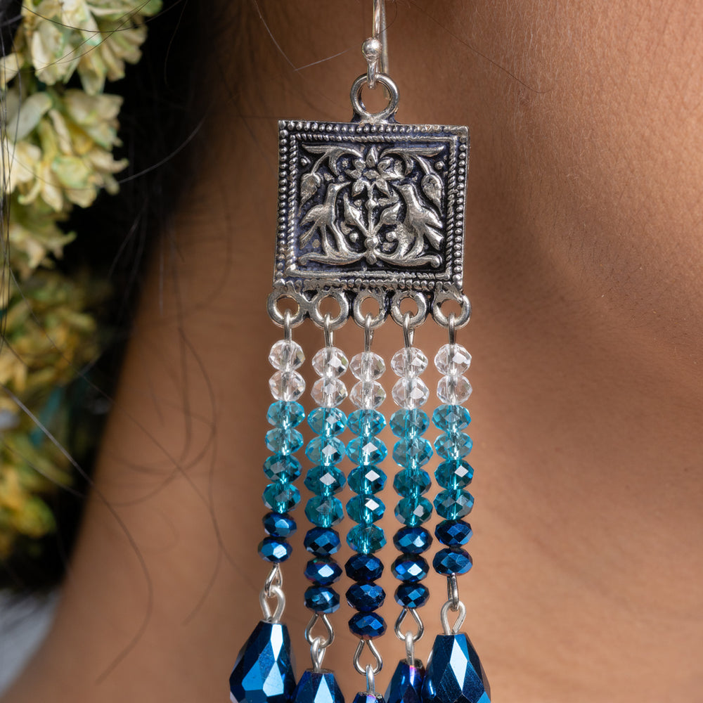 Handmade blue crystal earrings with silver decorative top and dangling blue and clear beads