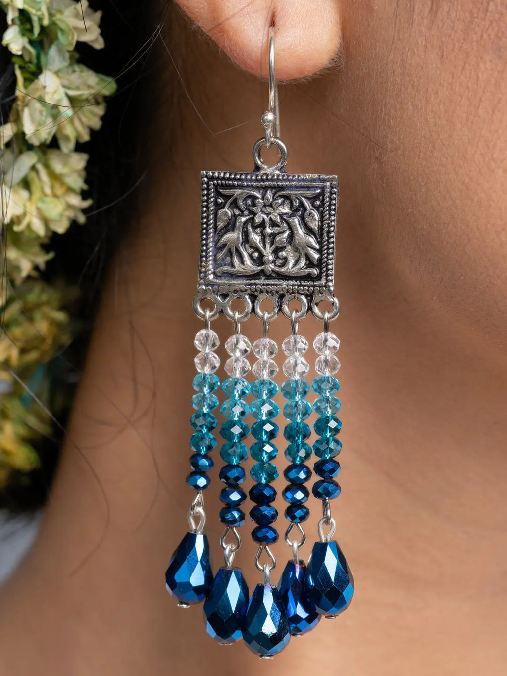 Handmade blue crystal earrings with silver decorative top and dangling blue and clear beads