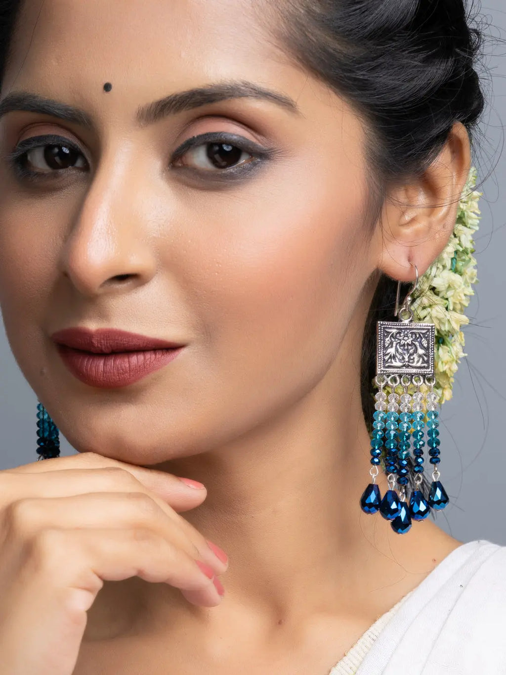 Handmade blue crystal earrings by LOOK AND ADORN worn by woman with traditional attire
