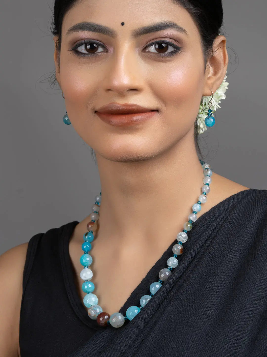 Blue Onyx Necklace Set on model wearing handmade beaded necklace and matching earrings by LOOK AND ADORN
