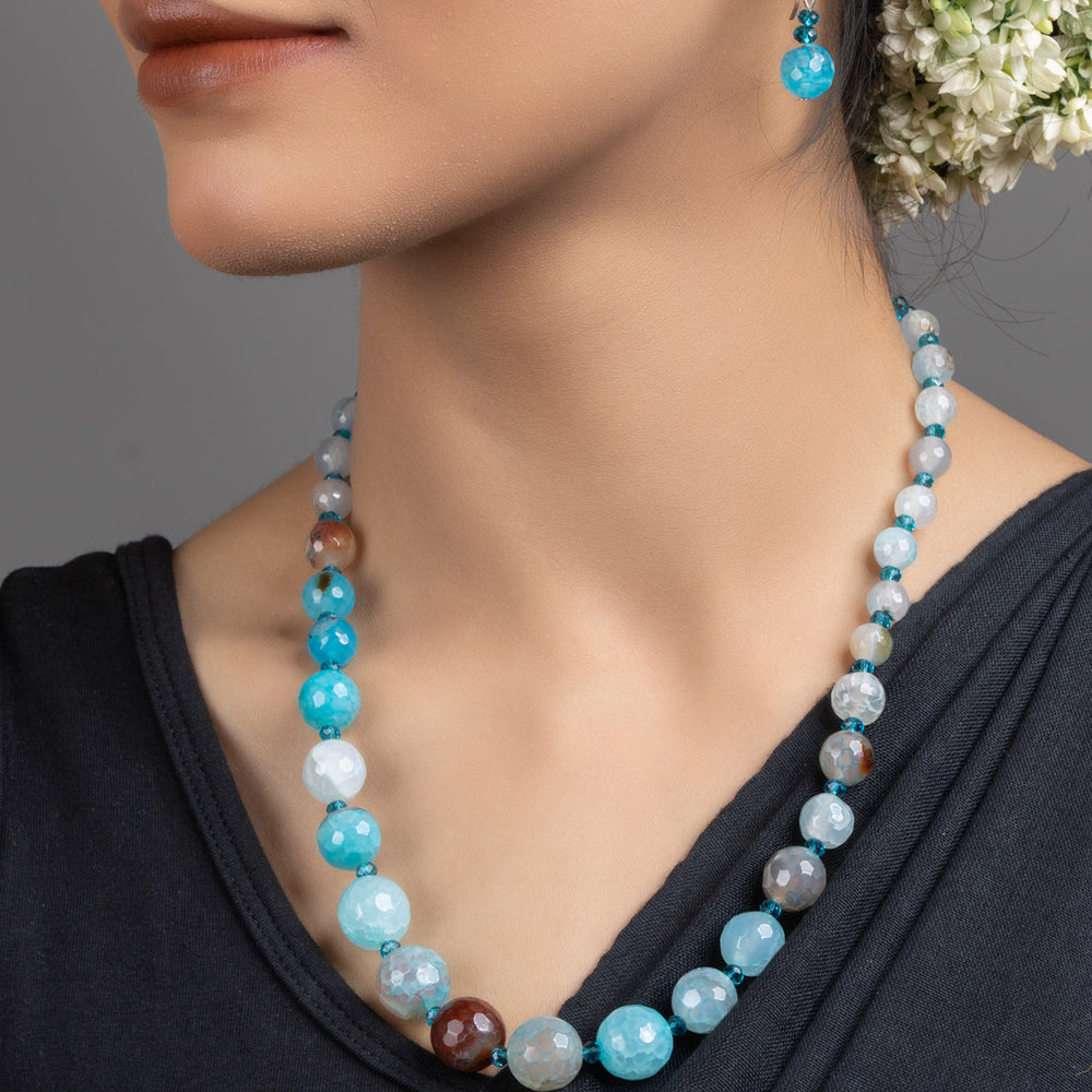 Handmade Blue Onyx Necklace Set by LOOK AND ADORN worn by model featuring graduated blue and aqua beads with matching earring