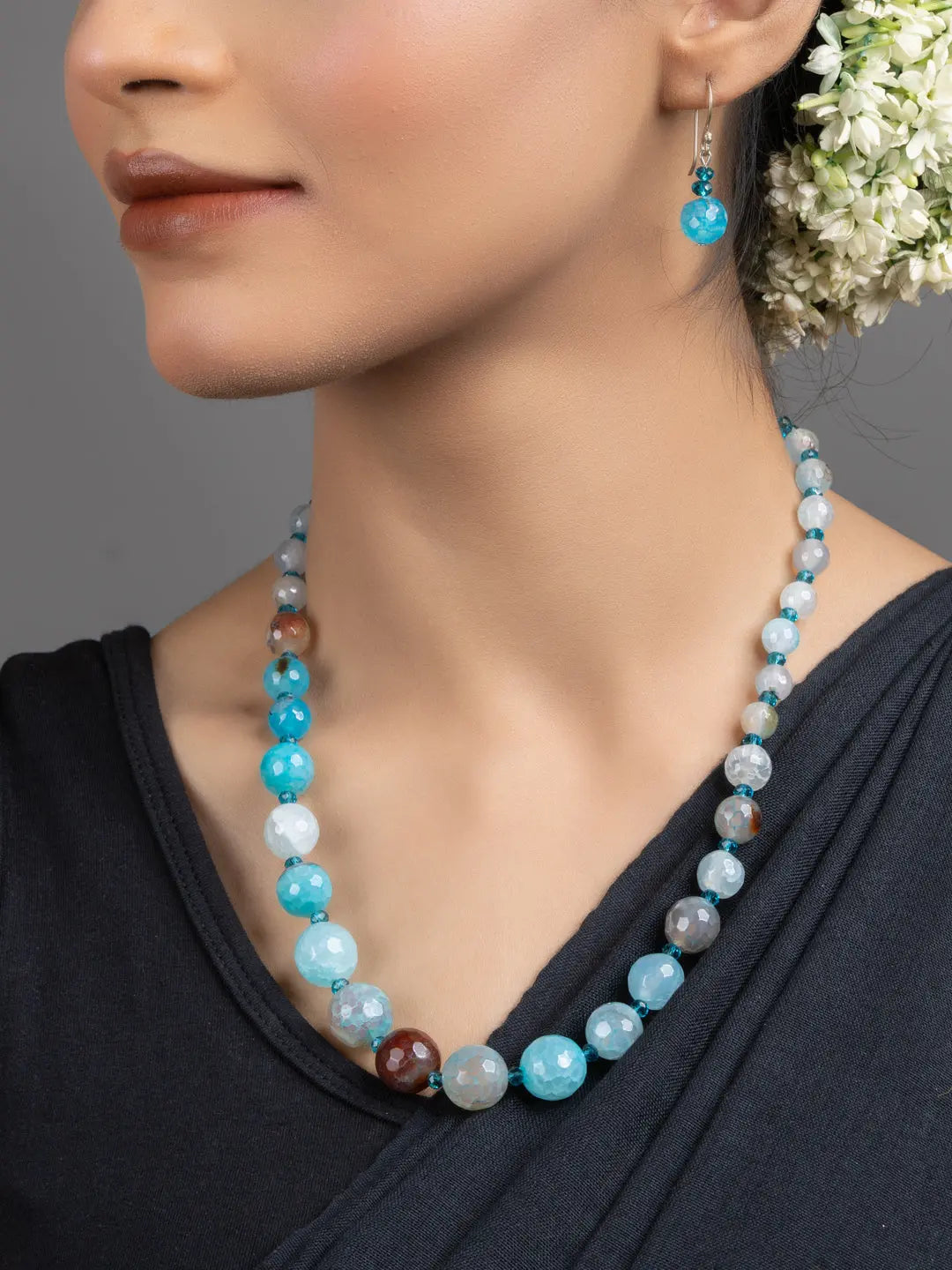 Handmade Blue Onyx Necklace Set by LOOK AND ADORN worn by model featuring graduated blue and aqua beads with matching earring