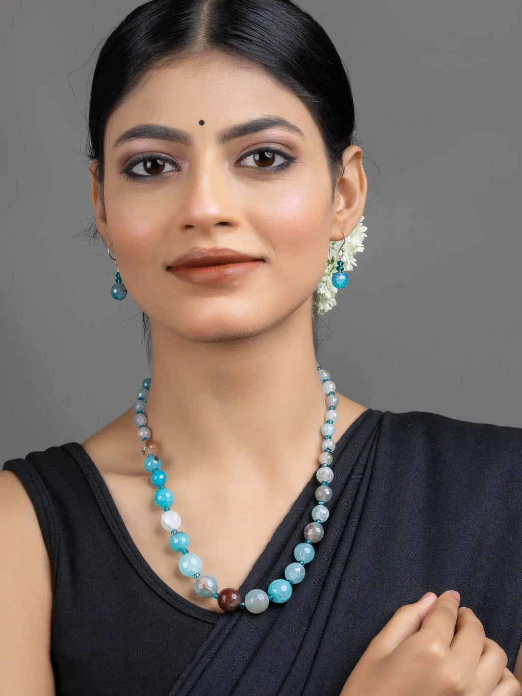 Blue Onyx Necklace Set model wearing turquoise and aqua beaded necklace with matching blue drop earrings