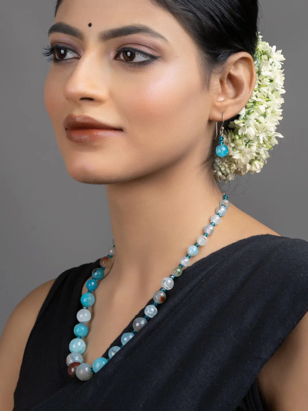 LOOK AND ADORN Blue Onyx Necklace Set worn by model with matching earrings and jasmine hair flowers
