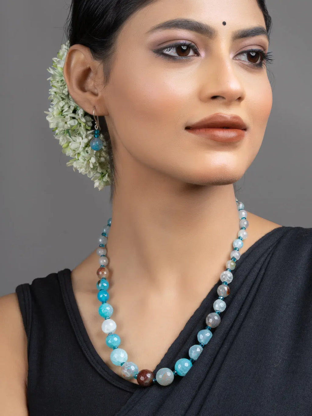 Blue Onyx Necklace Set on model featuring handmade blue and brown onyx beads with matching earrings