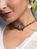 Handmade german silver choker necklace with intricate pendant on colorful braided cord worn by woman